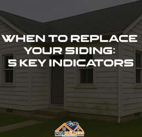 White house with aged siding showing signs of wear, discoloration, and mild mold—used to illustrate signs it's time to replace your home’s siding