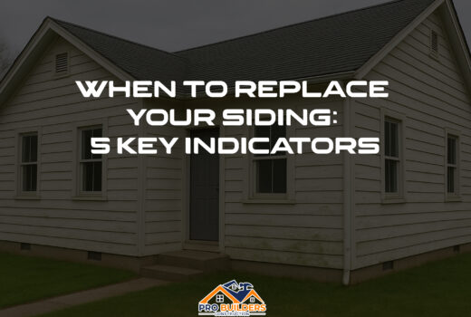 White house with aged siding showing signs of wear, discoloration, and mild mold—used to illustrate signs it's time to replace your home’s siding