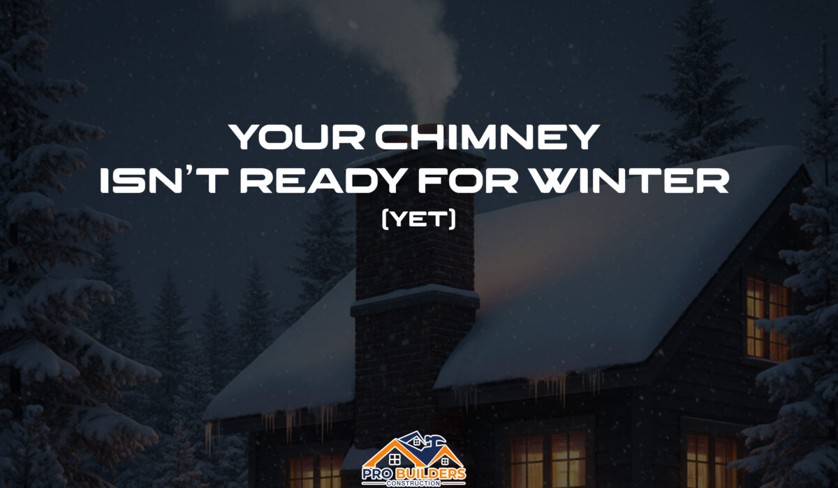 A photograph of a cozy brick home in winter, its roof and chimney covered in snow. Light smoke drifts from the chimney, and warm light glows from the windows during a gentle twilight snowfall.