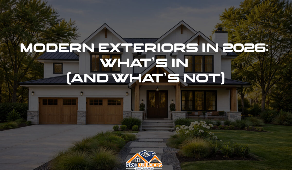 Modern US home with white board-and-batten siding, dark metal roof, wood accents, and landscaped yard, showcasing current exterior design trends.