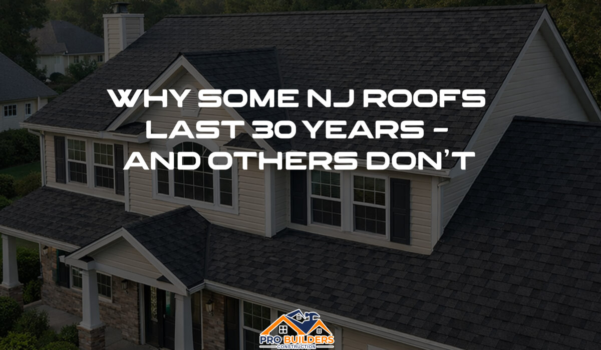 Two-story suburban New Jersey home with cream siding and white trim, featuring a newly installed charcoal gray architectural shingle roof highlighted in warm late-afternoon light.