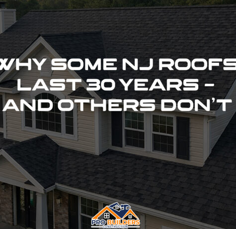 Two-story suburban New Jersey home with cream siding and white trim, featuring a newly installed charcoal gray architectural shingle roof highlighted in warm late-afternoon light.