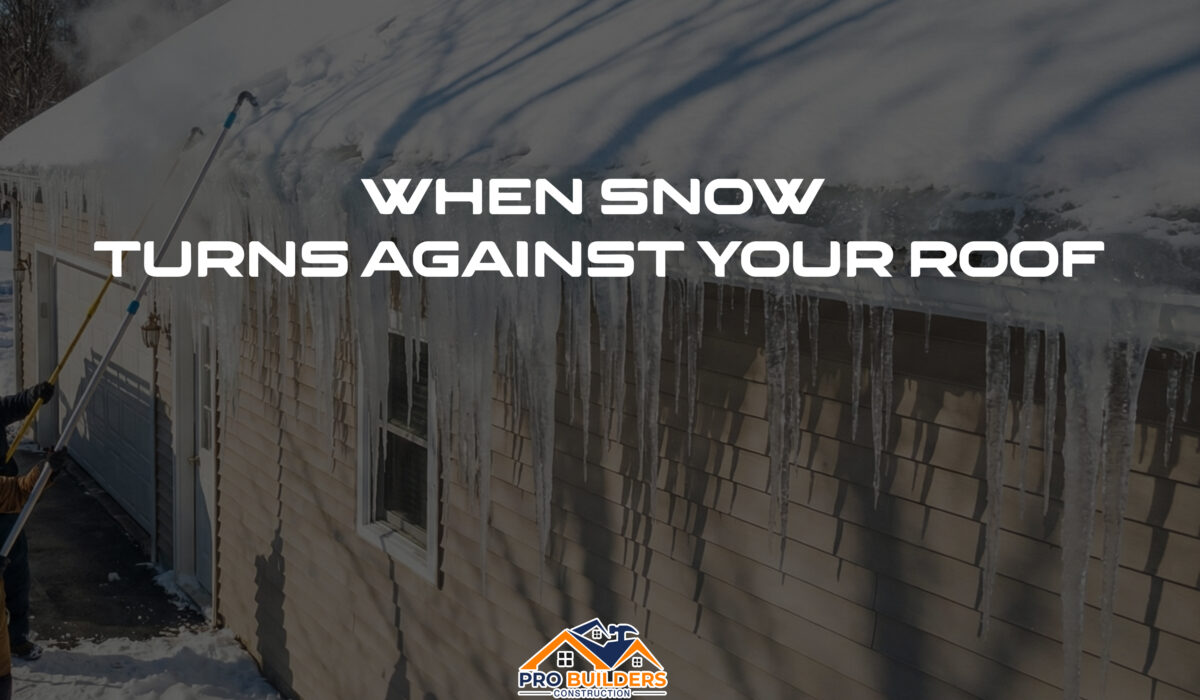 Workers using a long roof rake to remove heavy snow from the edge of a house roof lined with large icicles, with the text “When Snow Turns Against Your Roof” displayed across the image and a Pro Builders Construction logo at the bottom.