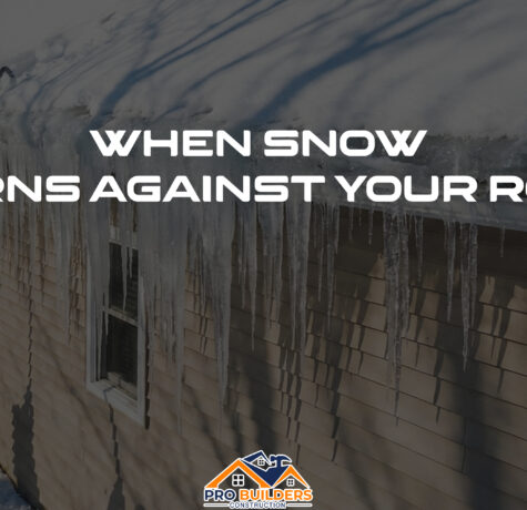Workers using a long roof rake to remove heavy snow from the edge of a house roof lined with large icicles, with the text “When Snow Turns Against Your Roof” displayed across the image and a Pro Builders Construction logo at the bottom.